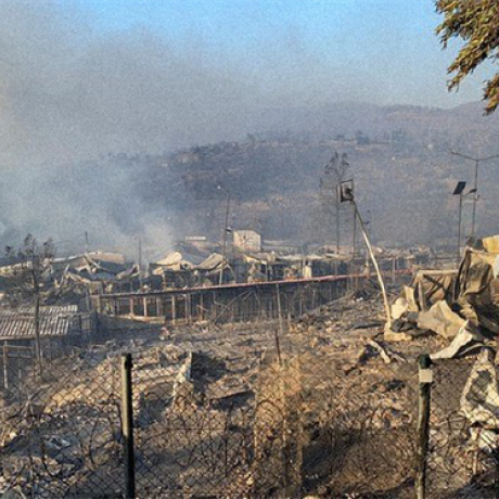 View of the refugee camp Moira in Lesvos, Greece, smokes is coming from the settlement